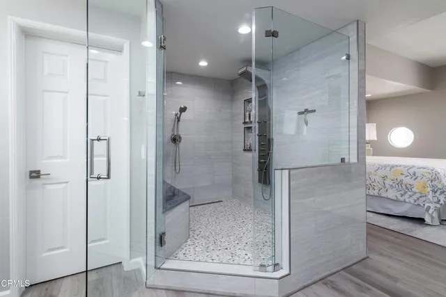 a bathroom with a glass shower door and a bathtub