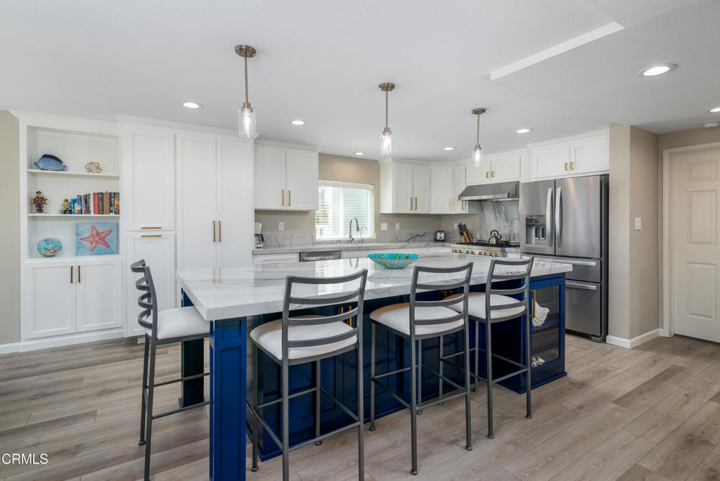 117 Santa Cruz Avenue Oxnard, CA 93035 - Photo 2 of 35 a kitchen with a dining table chairs stainless steel appliances and cabinets
