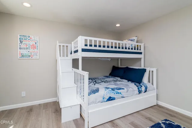 a view of bedroom with furniture and wooden floor