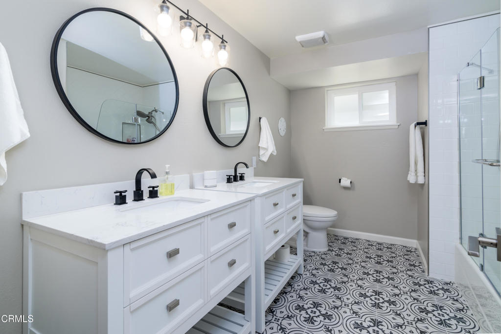 117 Santa Cruz Avenue Oxnard, CA 93035 - Photo 30 of 35 a bathroom with a double vanity sink mirror and a toilet