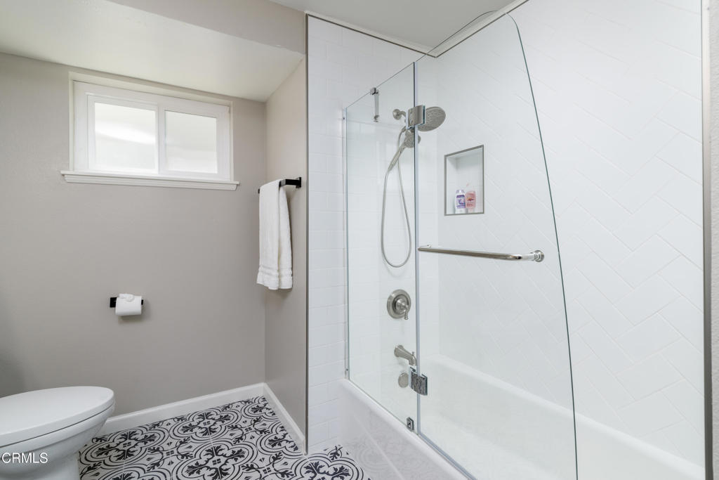 117 Santa Cruz Avenue Oxnard, CA 93035 - Photo 31 of 35 a bathroom with a shower a toilet and a window
