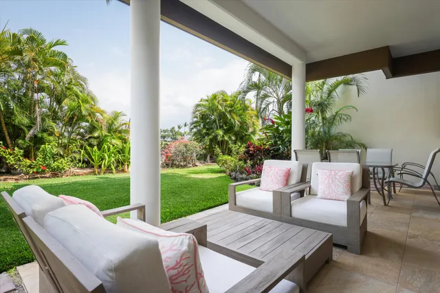 a view of a patio with a table chairs and a backyard
