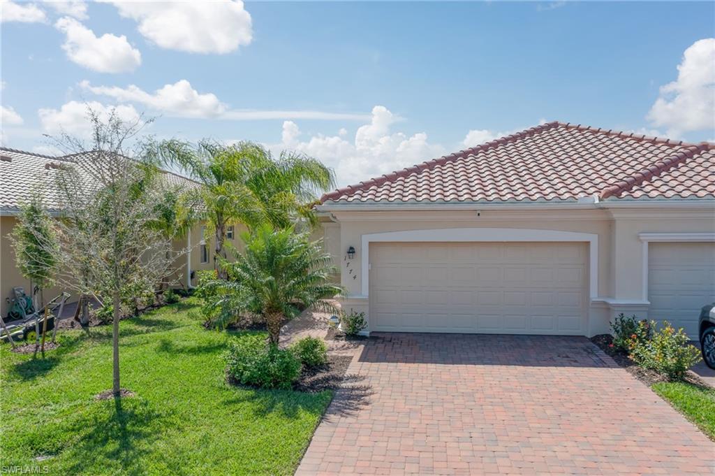 1774 Alameda Drive Naples, FL 34120 - Photo 1 of 29 a front view of a house with garden