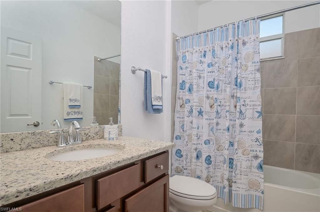 1774 Alameda Drive Naples, FL 34120 - Photo 16 of 29 a bathroom with a granite countertop sink toilet and shower