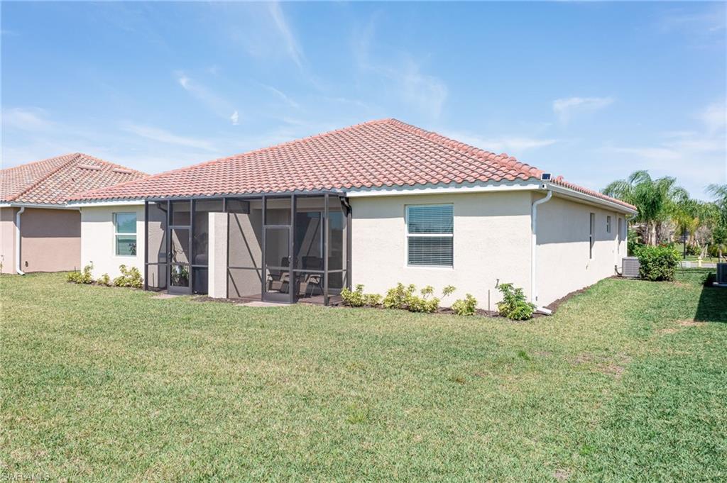 1774 Alameda Drive Naples, FL 34120 - Photo 21 of 29 a front view of a house with a garden