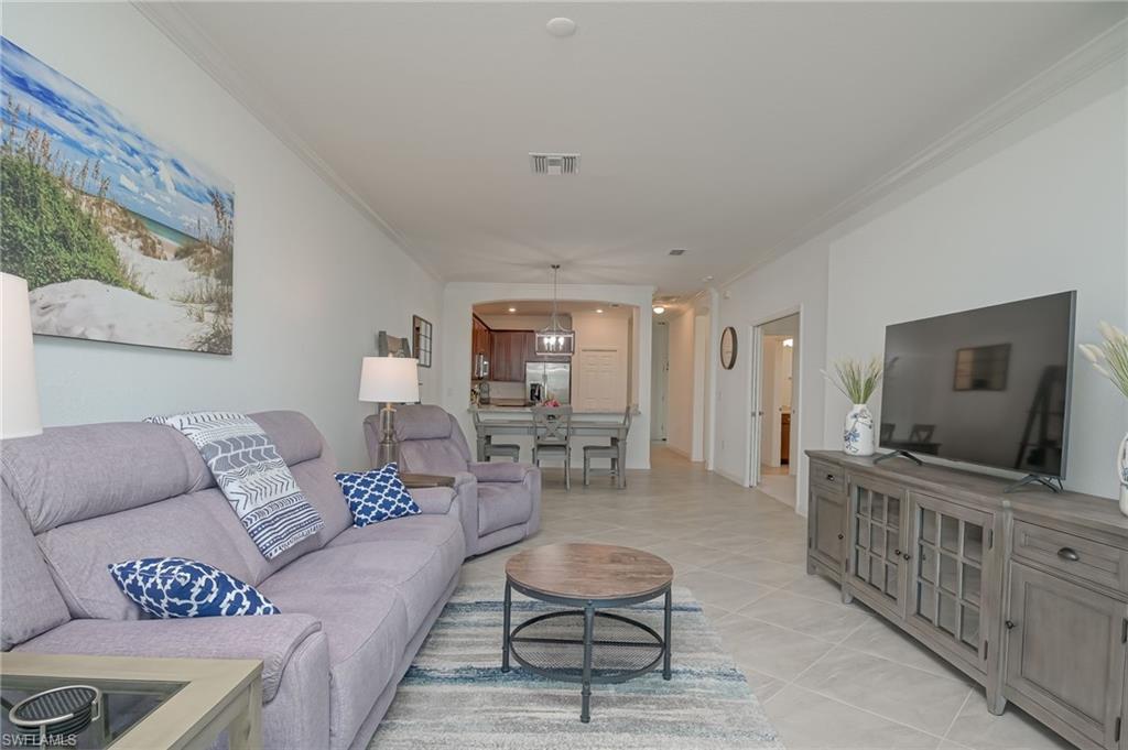1774 Alameda Drive Naples, FL 34120 - Photo 6 of 29 a living room with furniture and a flat screen tv