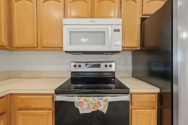 a stove top oven sitting inside of a kitchen