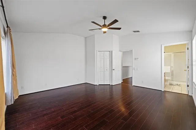 a bedroom with a bed and a potted plant