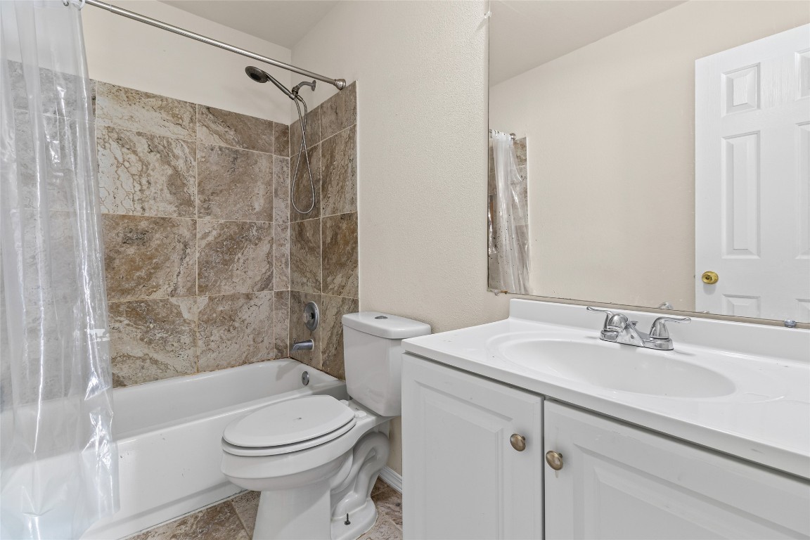 12700 St Mary Drive Manor, TX 78653 - Photo 14 of 17 a bathroom with a sink toilet and shower