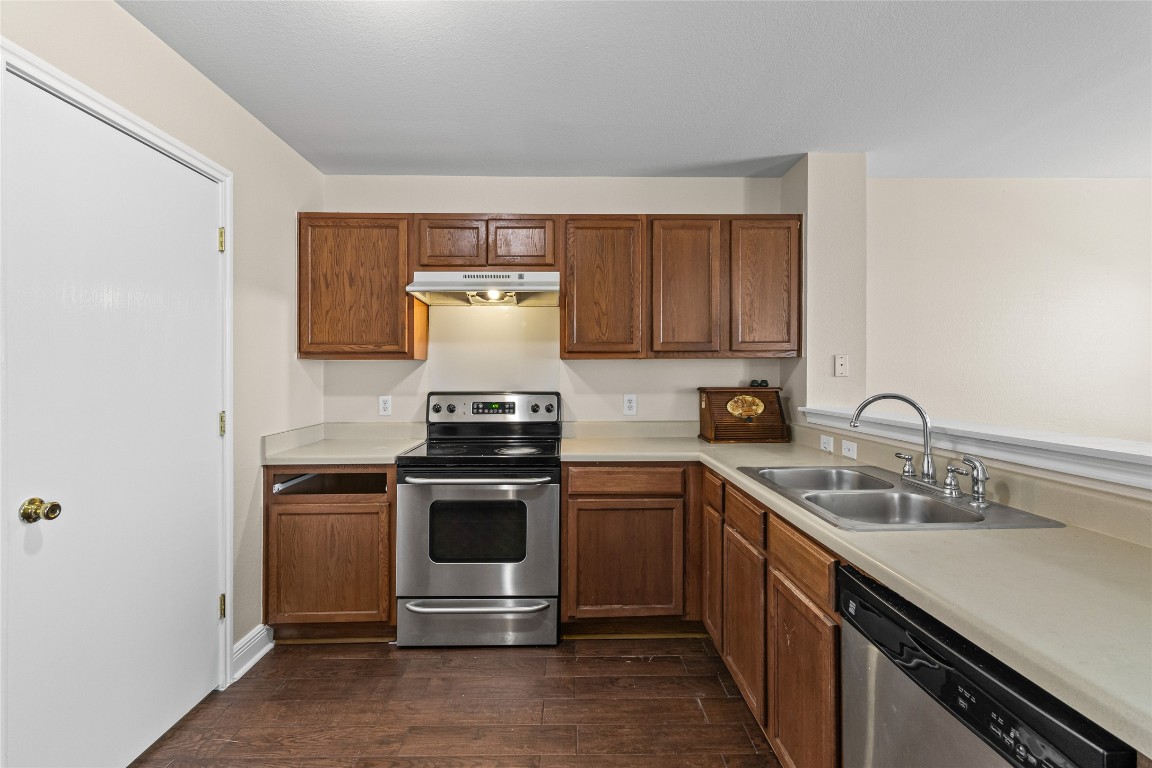 12700 St Mary Drive Manor, TX 78653 - Photo 7 of 17 a kitchen with a stove and a sink