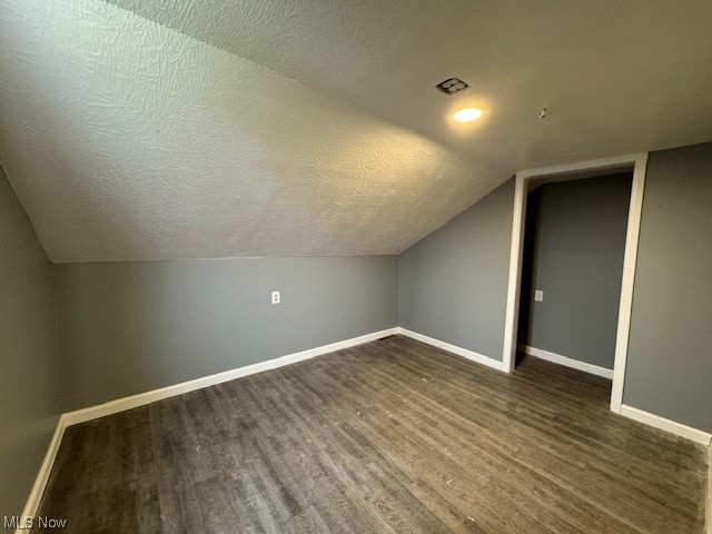 10264 Tallmadge Road Diamond, OH 44412 - Photo 29 of 32 Additional living space with a textured ceiling, dark hardwood / wood-style floors, and lofted ceiling