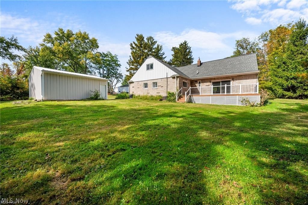 28300 Aurora Road Solon, OH 44139 - Photo 35 of 36 Expansive green lawn featuring a large detached outbuilding and a brick exterior residence