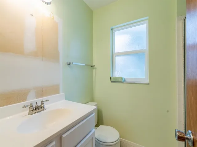 a bathroom with a sink a toilet and vanity