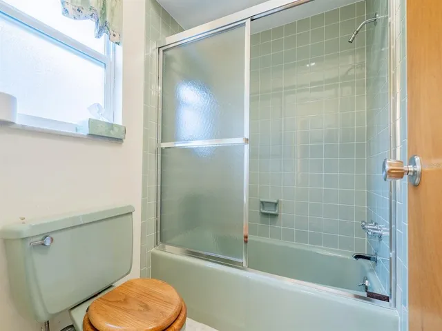 a bathroom with a shower and a toilet