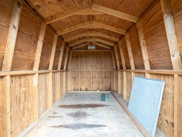 a swimming pool with potted plants and large trees