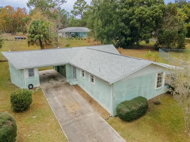 a aerial view of a house with a yard