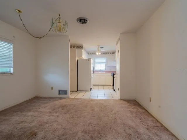 a view of a room with a sink and a mirror