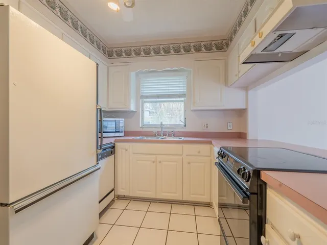 a kitchen with a sink cabinets and window