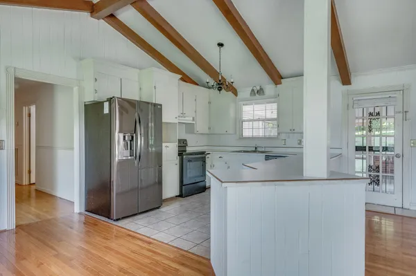 a kitchen with stainless steel appliances granite countertop a refrigerator a sink and a stove