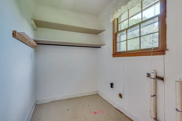 a small space with a window and a fan