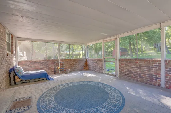 a view of a livingroom with furniture and floor to ceiling window