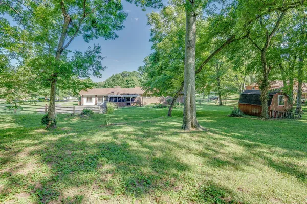 a view of a house with backyard porch and sitting area