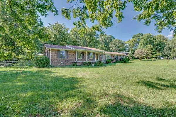 a view of a house with a backyard