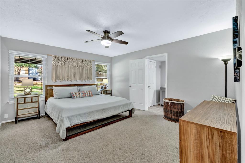 2609 Quail Ridge Irving, TX 75060 - Photo 13 of 39 a bedroom with a bed and a chandelier