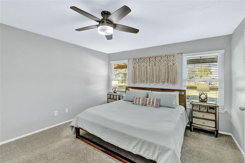 2609 Quail Ridge Irving, TX 75060 - Photo 15 of 39 a bedroom with a bed chandelier and a window