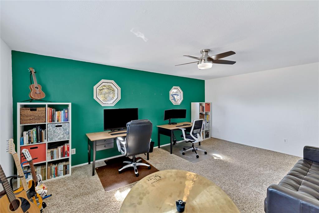 2609 Quail Ridge Irving, TX 75060 - Photo 23 of 39 a work room with furniture and a bookshelf