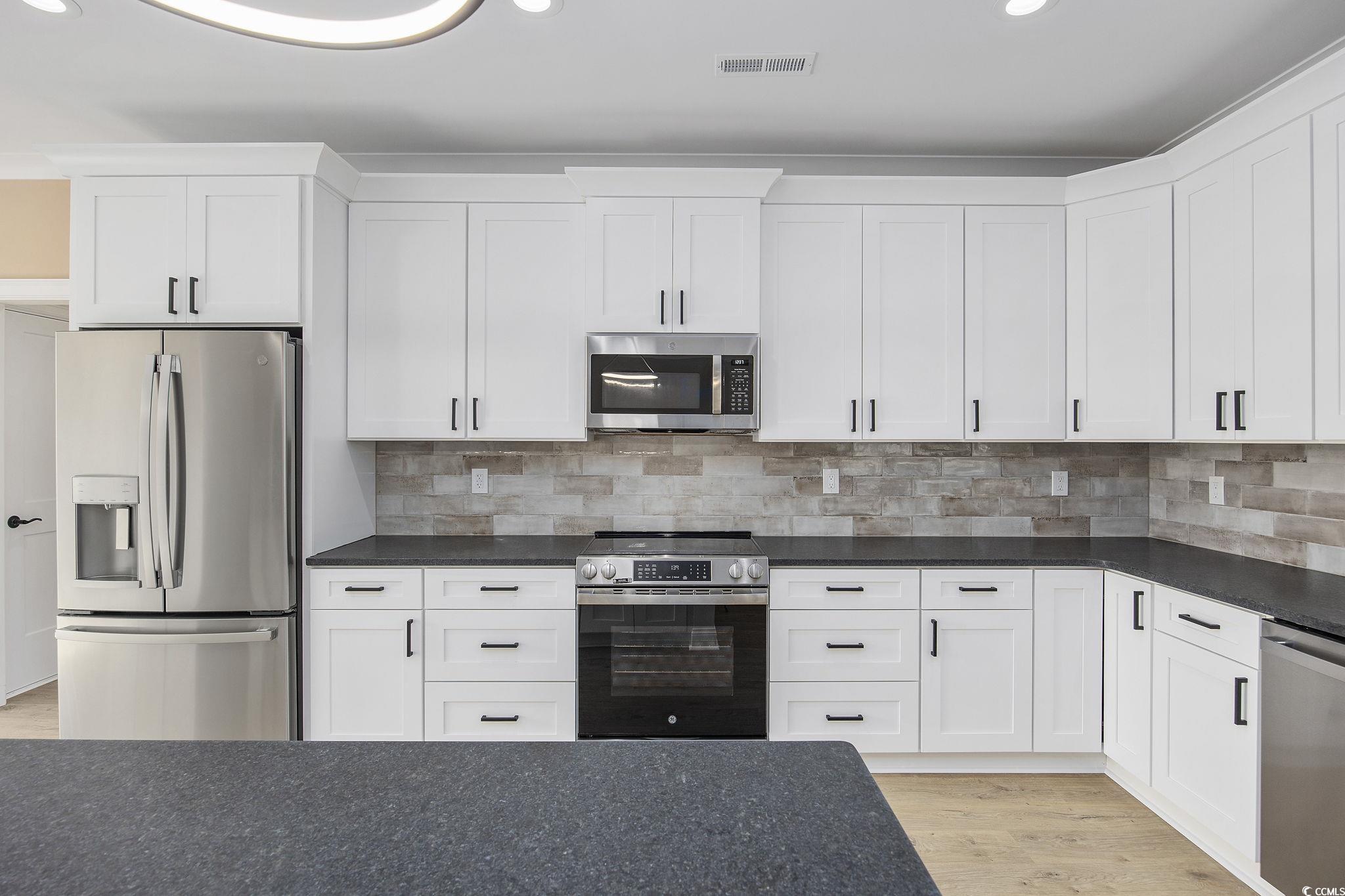 6914 Pauley Swamp Road Conway, SC 29527 - Photo 12 of 40 Kitchen with backsplash, appliances with stainless