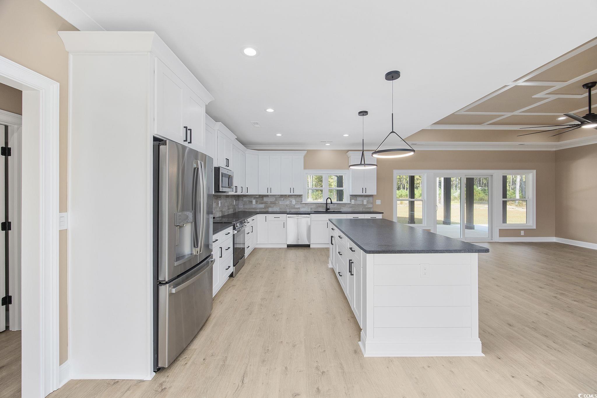 6914 Pauley Swamp Road Conway, SC 29527 - Photo 13 of 40 Kitchen with a center island, appliances with stai