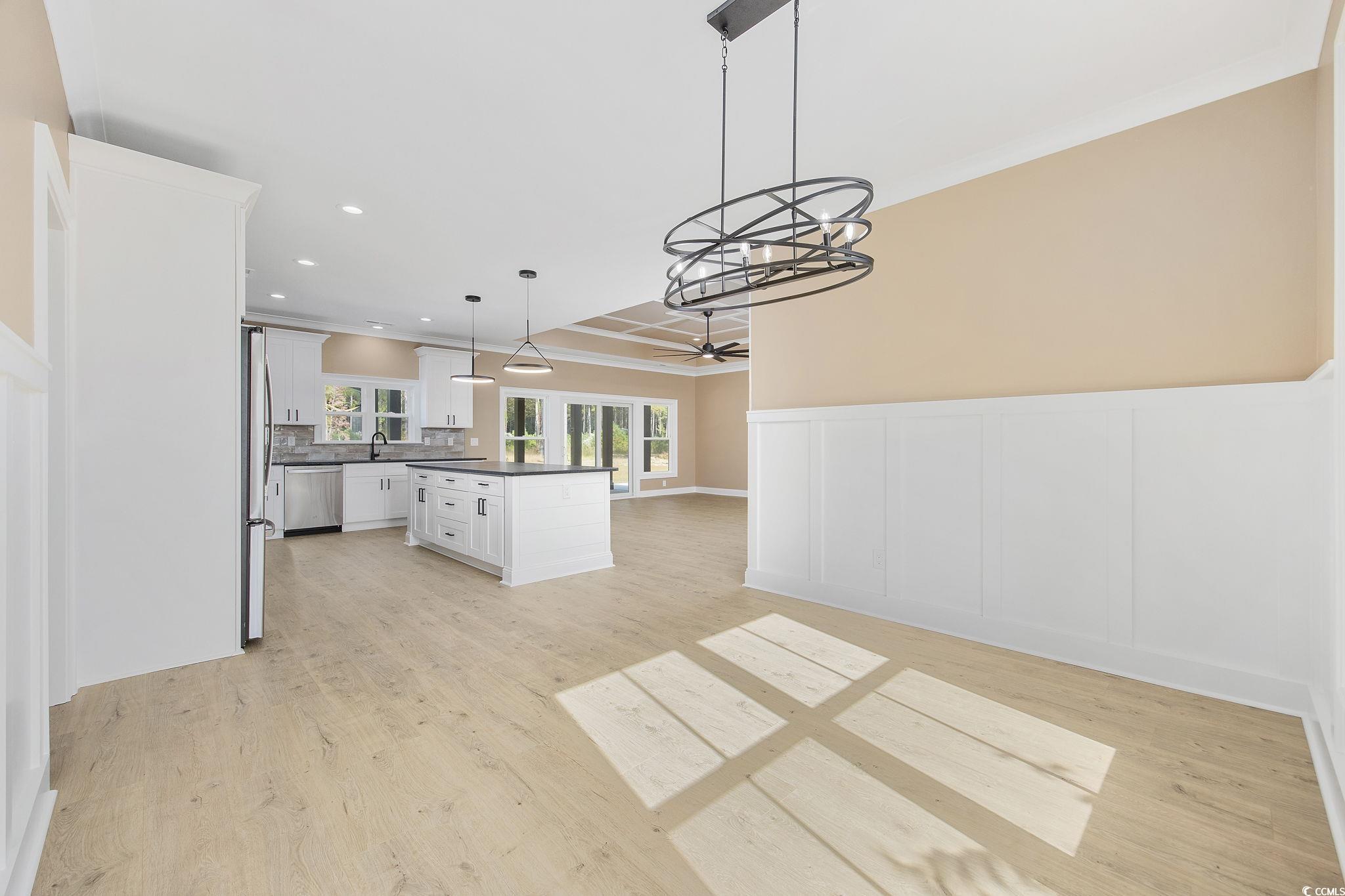 6914 Pauley Swamp Road Conway, SC 29527 - Photo 18 of 40 Kitchen with white cabinetry, light hardwood / woo