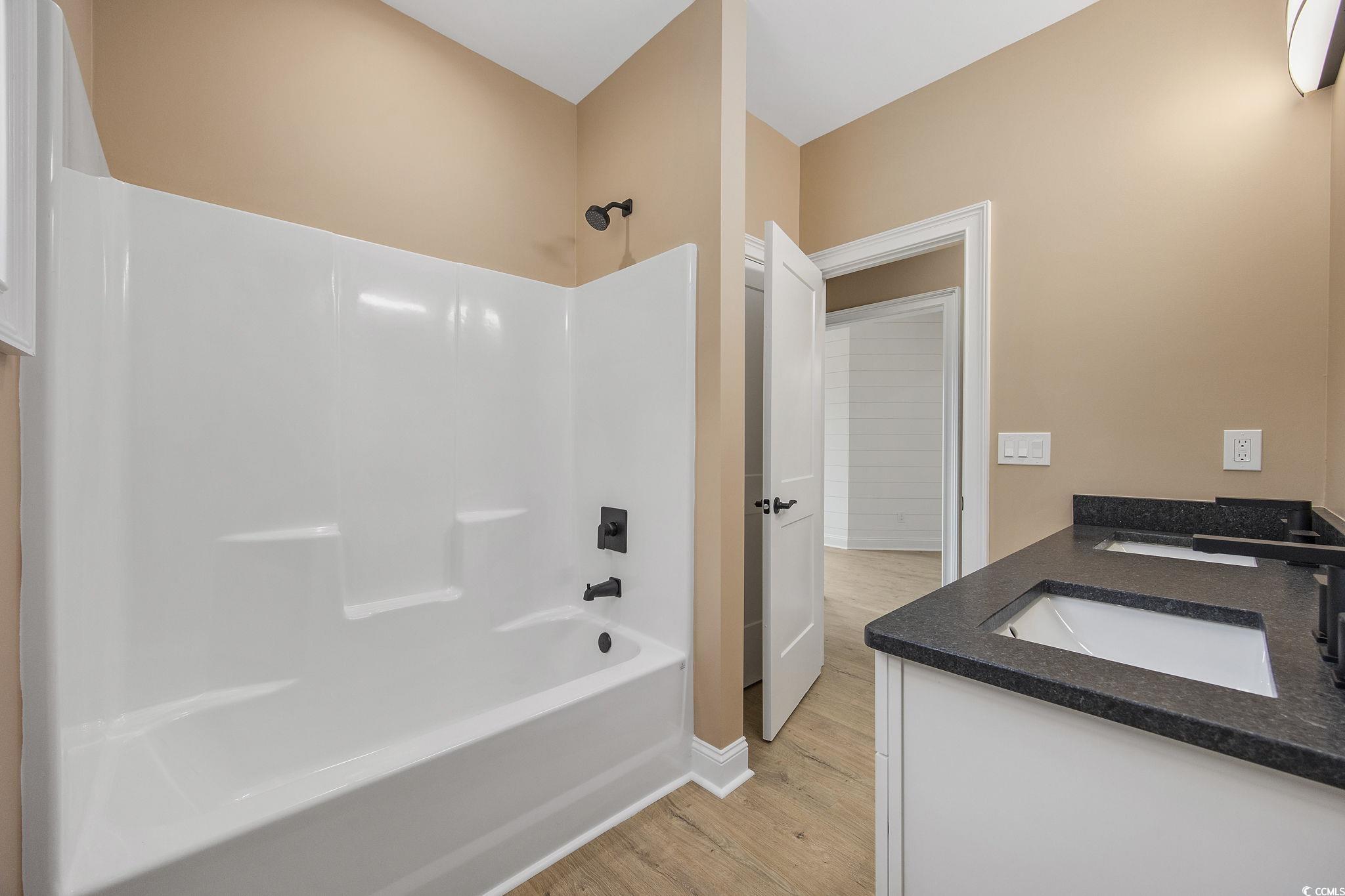 6914 Pauley Swamp Road Conway, SC 29527 - Photo 22 of 40 Bathroom with vanity, wood-type flooring, and show