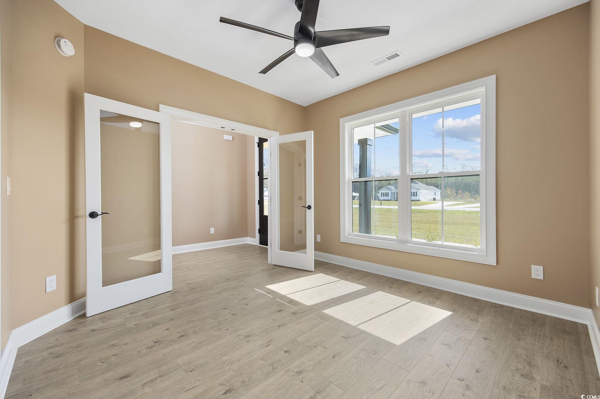 6914 Pauley Swamp Road Conway, SC 29527 - Photo 24 of 40 Unfurnished bedroom featuring french doors, light