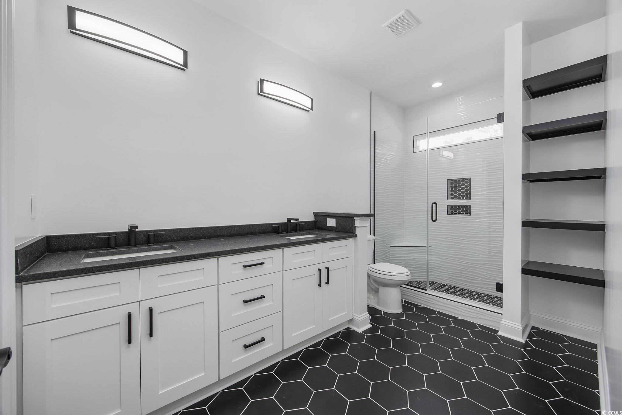 6914 Pauley Swamp Road Conway, SC 29527 - Photo 28 of 40 Bathroom with vanity, tile patterned floors, toile