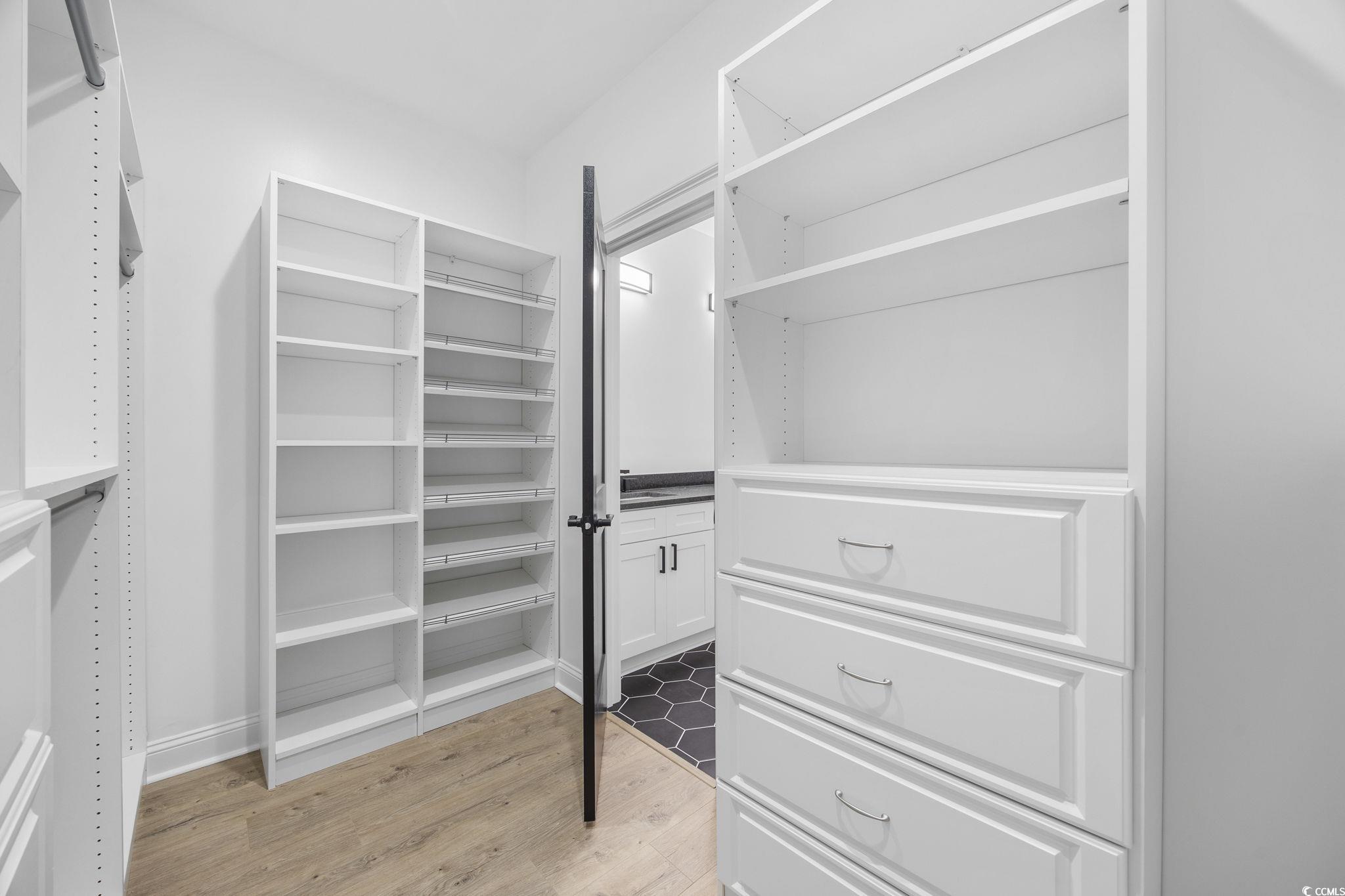 6914 Pauley Swamp Road Conway, SC 29527 - Photo 30 of 40 Walk in closet with light hardwood / wood-style fl