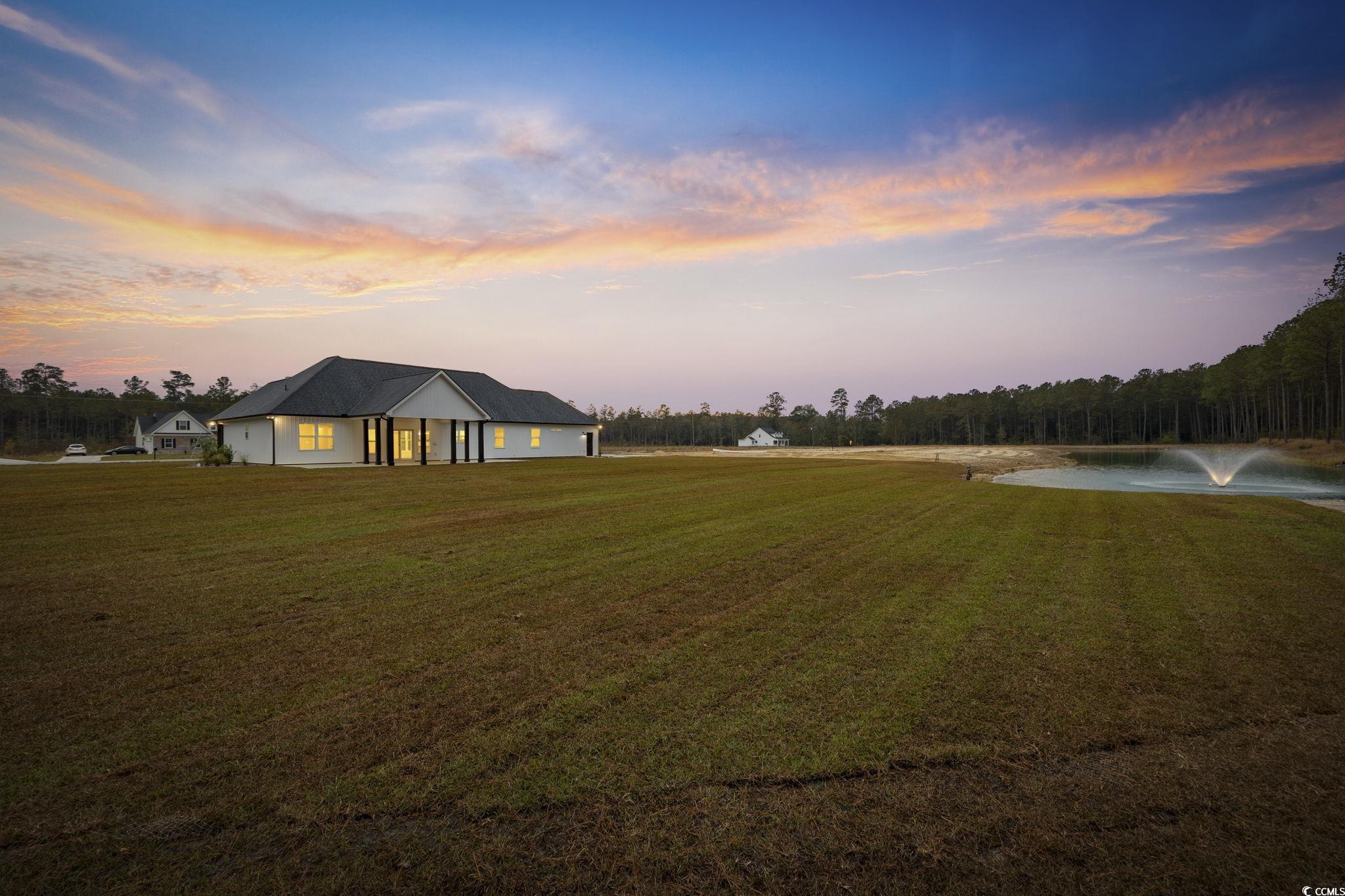 6914 Pauley Swamp Road Conway, SC 29527 - Photo 5 of 40 Yard at dusk with a water view