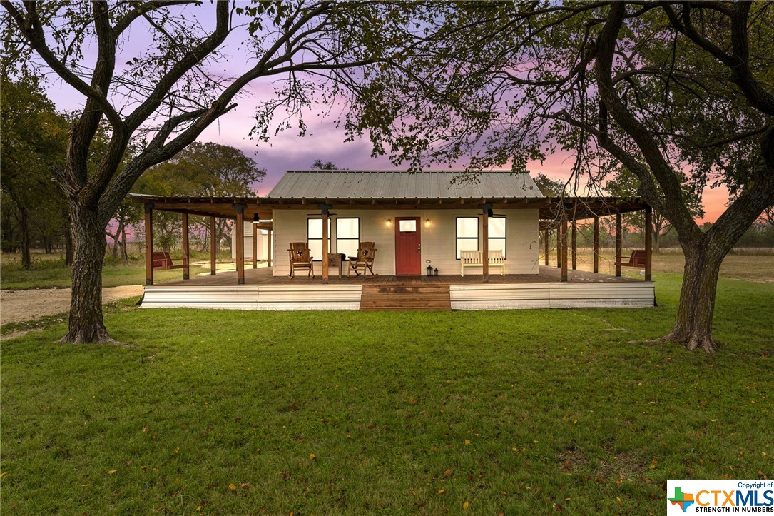 a swimming pool with outdoor seating and yard