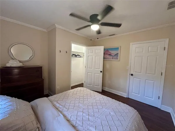 a bedroom with a bed and a chandelier