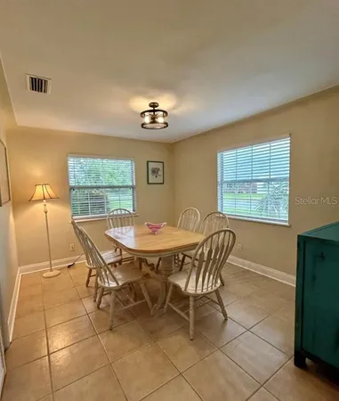 a view of a dining room with furniture and window