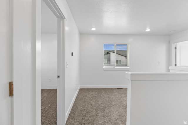 1271 West 500 South Logan, UT 84321 - Photo 19 of 26 Light-filled interior space featuring neutral carpeting and white wall finishes