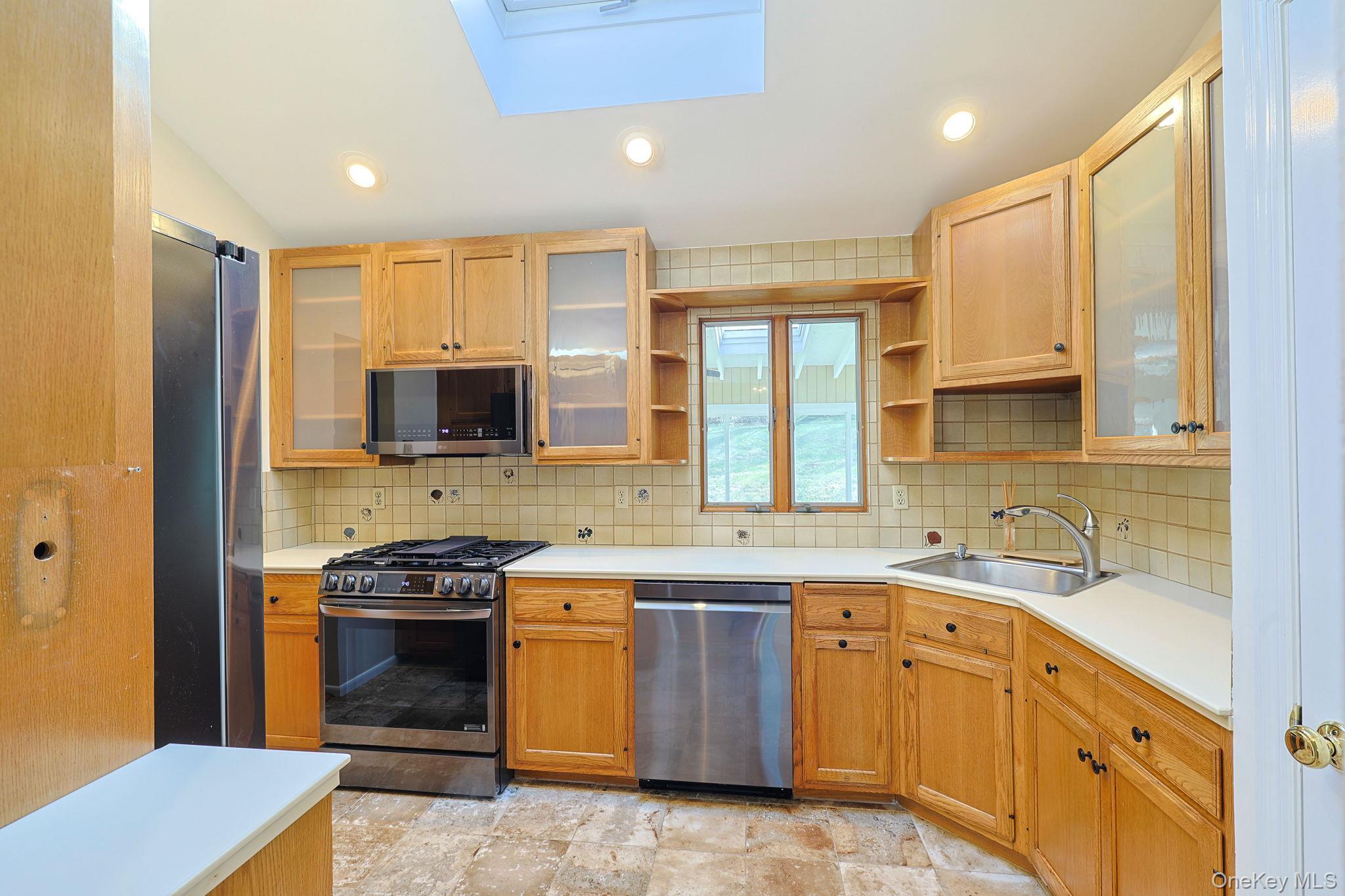 210 Varian Road Cortlandt Manor, NY 10567 - Photo 11 of 29 a kitchen with stainless steel appliances granite countertop a sink stove and refrigerator