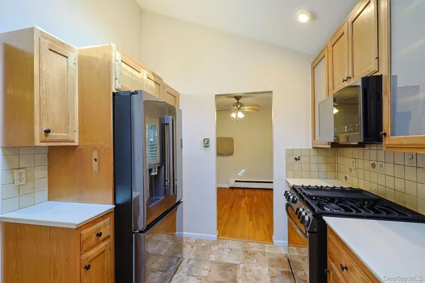 a kitchen with stainless steel appliances granite countertop a refrigerator and a stove