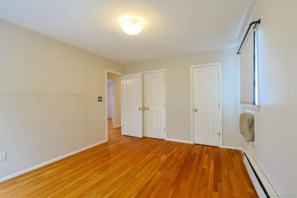 a view of a room with wooden floor
