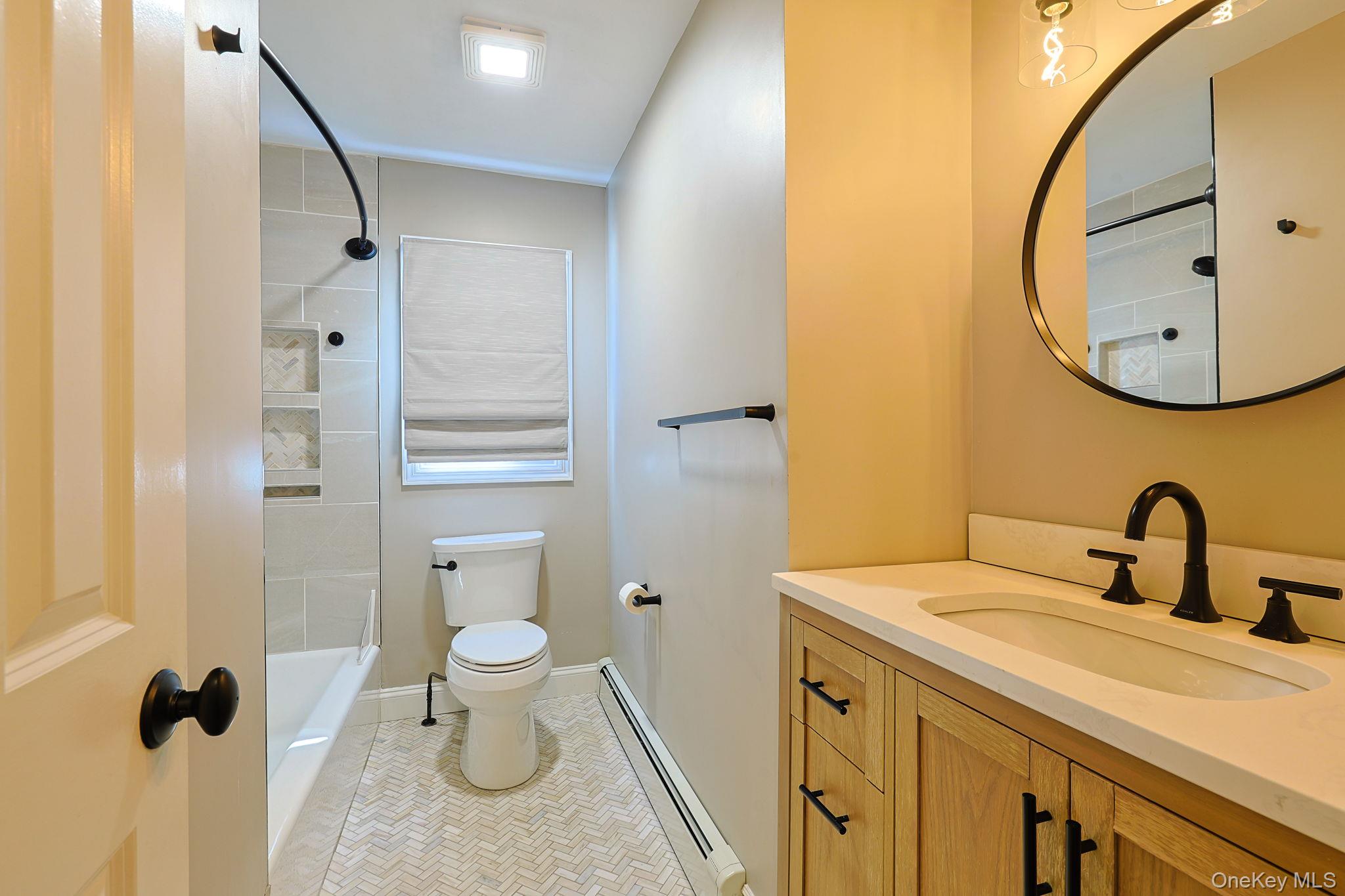 210 Varian Road Cortlandt Manor, NY 10567 - Photo 20 of 29 a bathroom with a toilet sink and mirror
