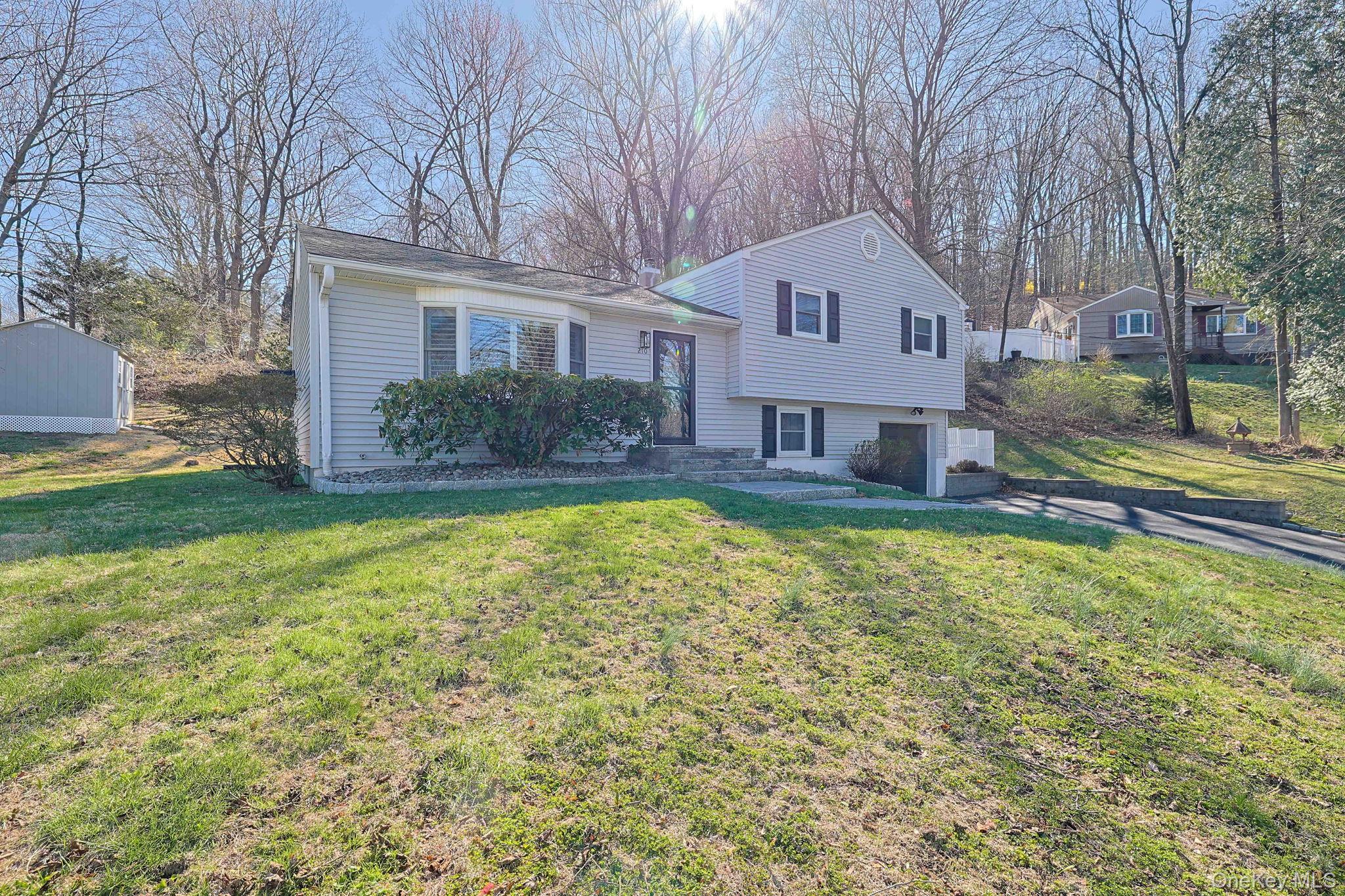 210 Varian Road Cortlandt Manor, NY 10567 - Photo 2 of 29 a front view of a house with a yard and trees