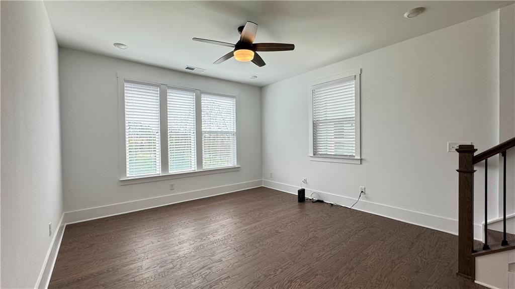 1585 Layton Lane Northwest Atlanta, GA 30318 - Photo 18 of 61 a view of empty room with wooden floor and fan
