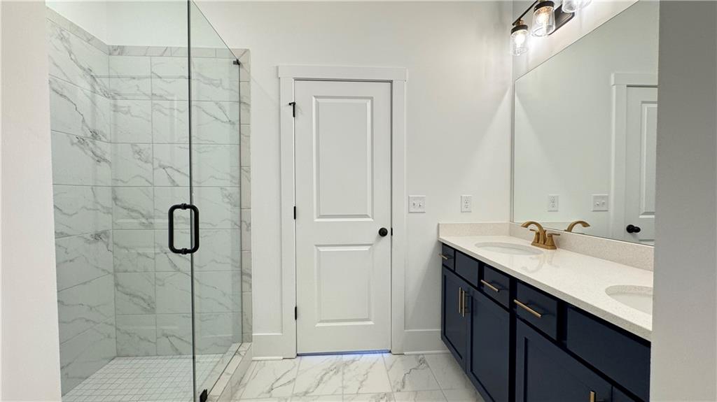 1585 Layton Lane Northwest Atlanta, GA 30318 - Photo 33 of 61 a bathroom with a shower sink and mirror