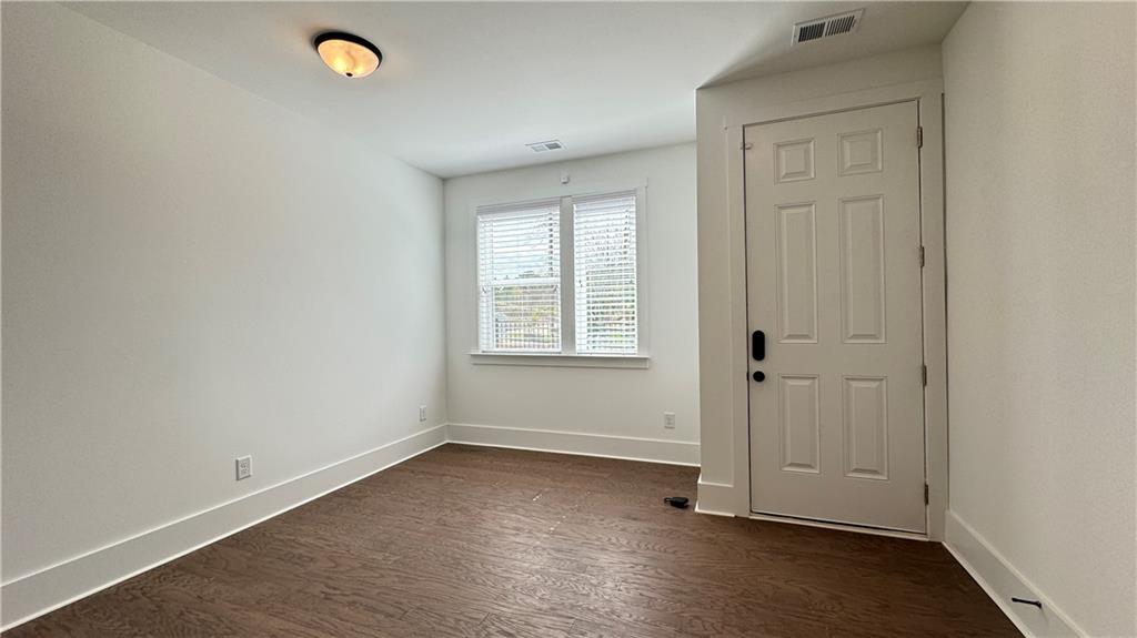 1585 Layton Lane Northwest Atlanta, GA 30318 - Photo 4 of 61 an empty room with wooden floor and windows